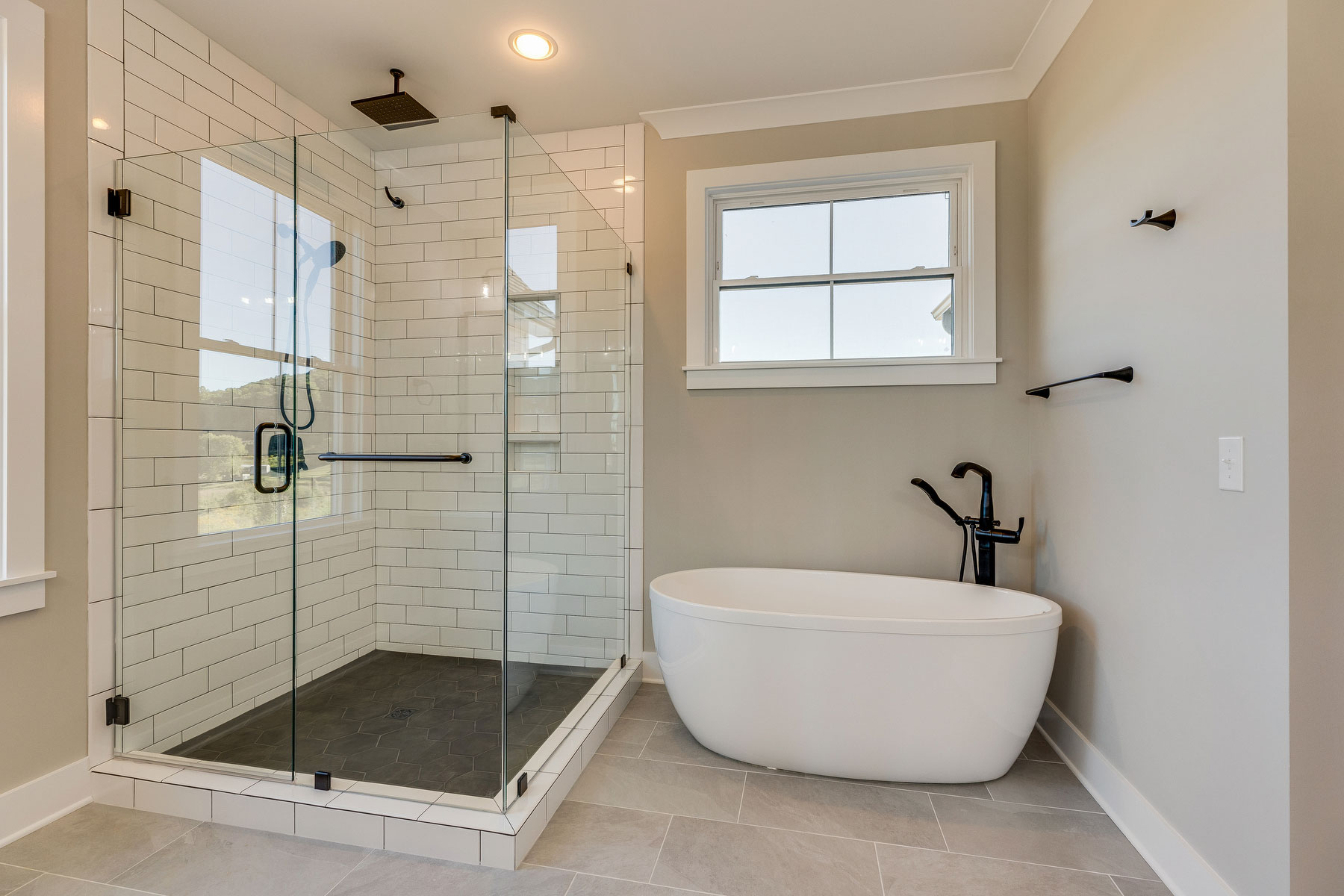 trumark construction custom home master bathroom tile shower and freestanding tub